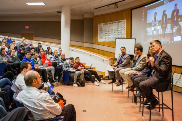 People attend a panel of guest speakers in a lecture hall on WSU campus.