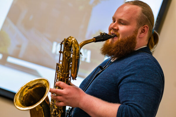 Student playing baritone saxophone