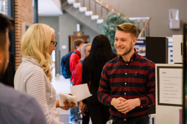 Students chat in the lobby of the Performing Arts Center before a show.