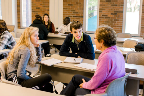 Students talk during a group discussion in class.