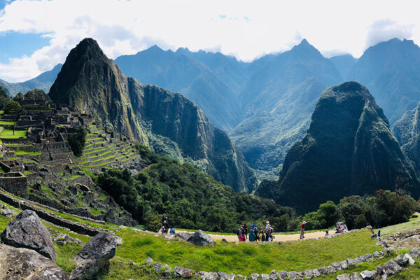 A group of people walk on a mountain path in South America.