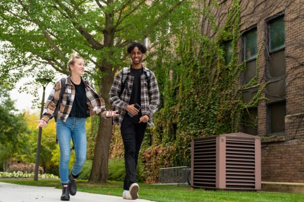 Two students walk past Phelps Hall on the WSU campus in Winona.