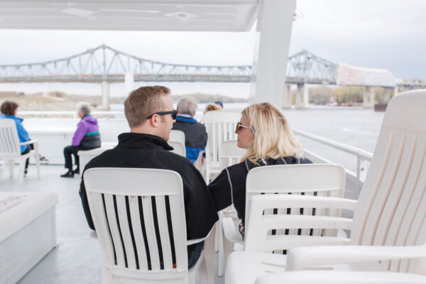 People chat on the deck of the Cal Fremling boat during an event.