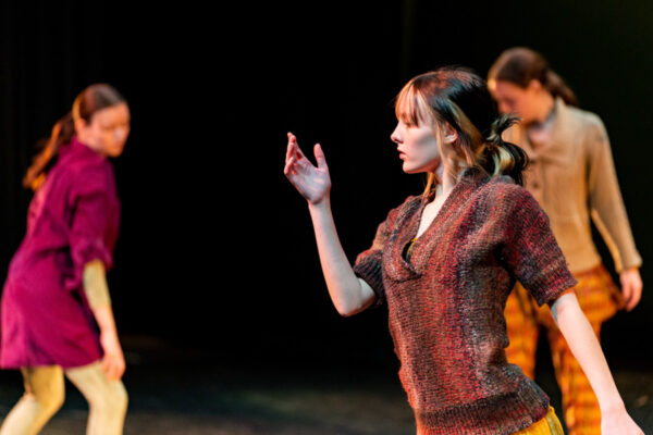 Three students dance during a performance at WSU.