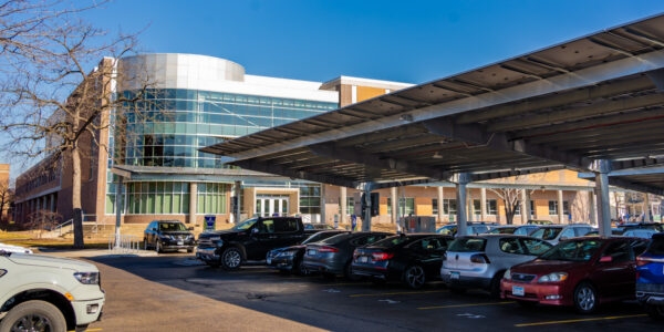 An exterior view of the Integrated Wellness Center and parking lot with solar panels on the WSU campus in Winona.