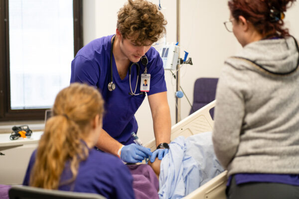 WSU nursing students practice their skills and provide care to a patient.