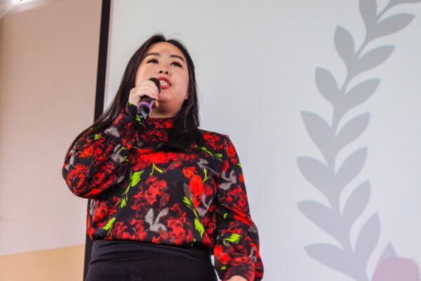 A female student gives a presentation during a campus event.