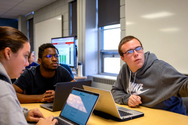 A group of students work together on a project during class.