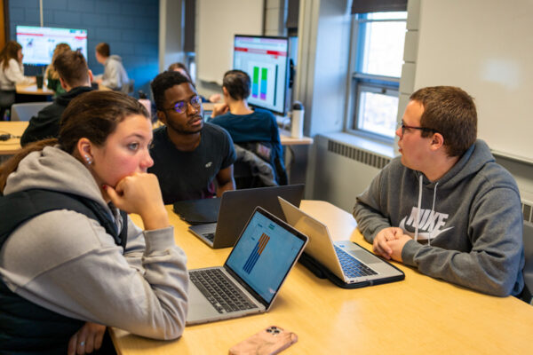 Students discuss a topic during class.