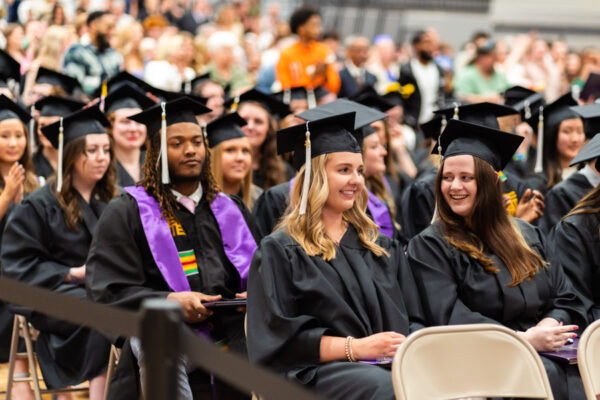 Graduates wearing caps and gowns sit during the WSU Commencement Ceremony.