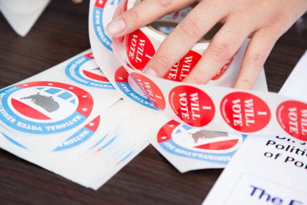 A person grabs an 'I Will Vote